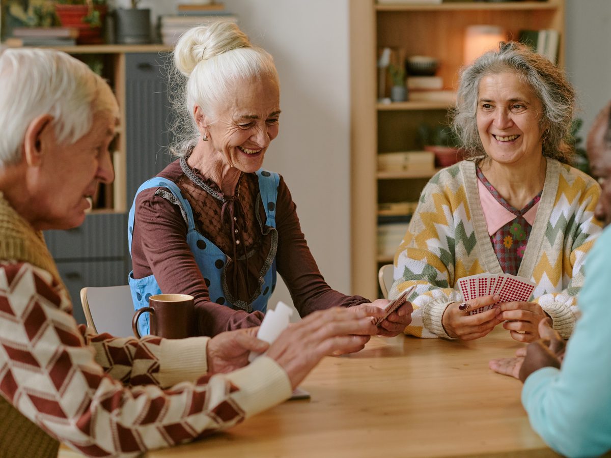 Older Australians enjoying a card game together indoors